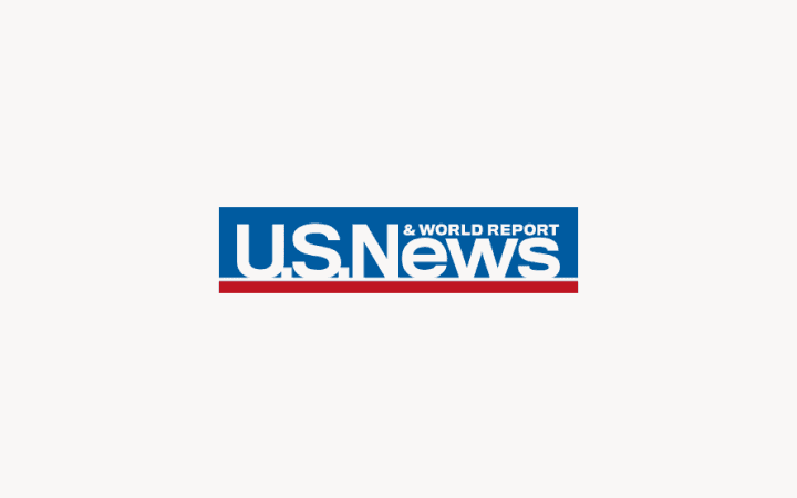 U.S. News & World Report logo with blue text on light pink background, featuring a red horizontal line underneath.